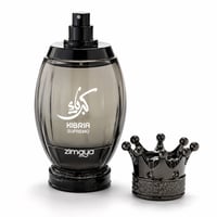 Zimaya Kibria Supremo — A smoky grey oval perfume bottle with white Arabic calligraphy and text 'KIBRIA SUPREMO ZIMAYA' stands next to a dark metallic crown-shaped cap on a white background.