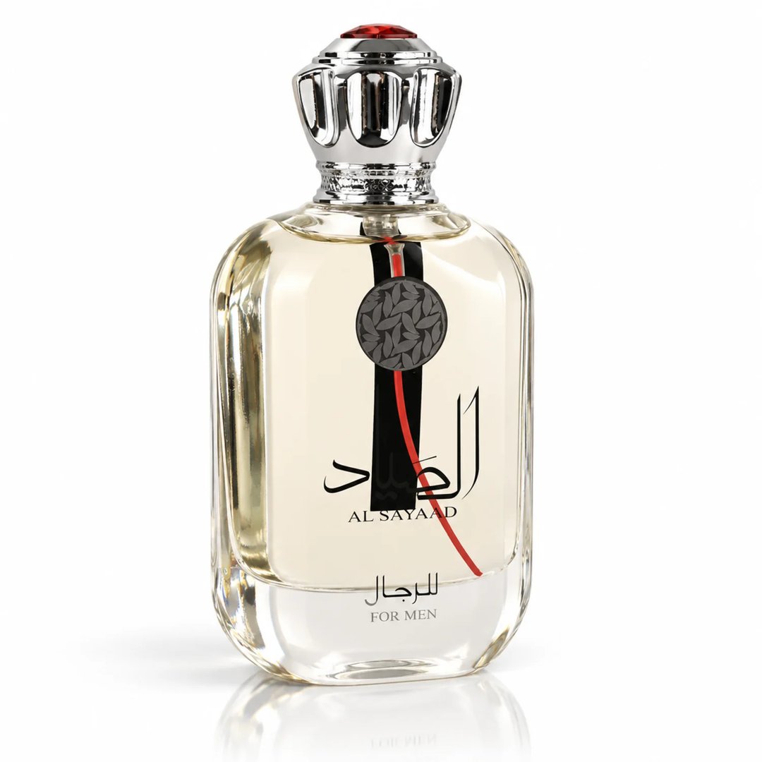 Ard Al Zaafaran Al Sayaad For Men — Clear glass perfume bottle with silver ornate cap, featuring Arabic script and a red and black design element on the label.