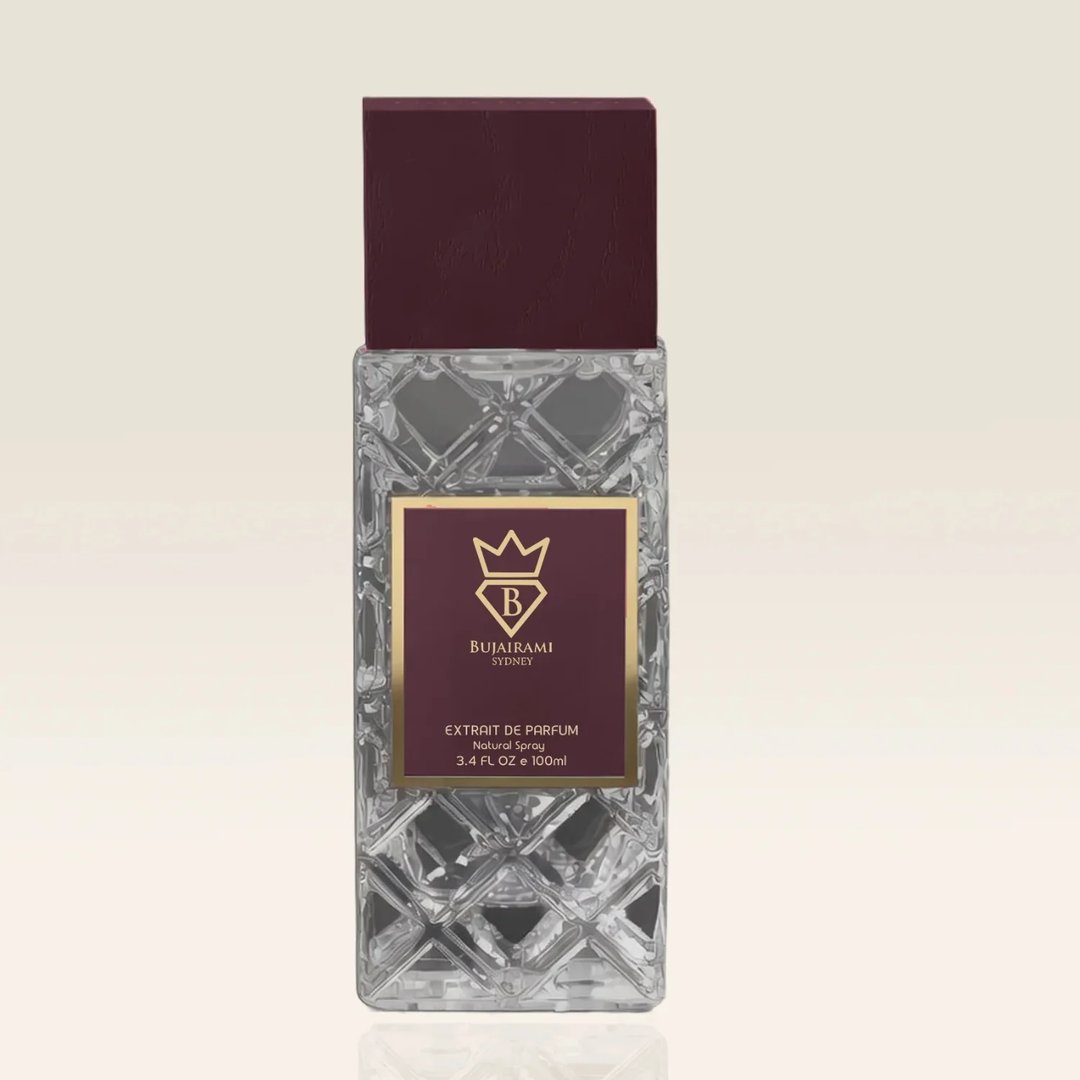 Bujairami Amber Eclipse by Bujairami 100ml Extrait — Clear faceted glass bottle with a deep maroon cap and a maroon label featuring a gold crown logo and text.