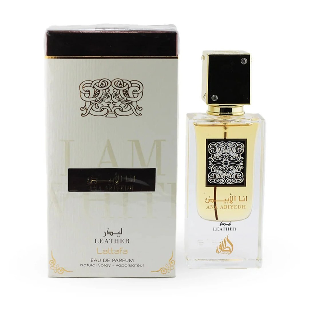 Lattafa Ana Abiyedh Leather 60ml by Lattafa Perfumes — A white perfume box with gold accents and Arabic calligraphy sits next to a clear glass perfume bottle with a gold cap and black accents, also featuring Arabic calligraphy. | Lattafa Ana Abiyedh Leather 60ml oleh Lattafa Perfumes — Kotak minyak wangi putih dengan