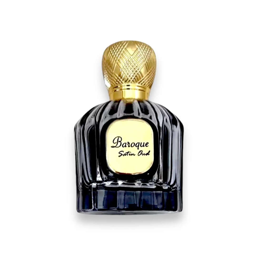 Maison Alhambra Baroque Satin Oud 100ml — A dark, fluted glass perfume bottle with a gold textured cap and a gold oval label reading "Baroque Satin Oud" in elegant script. | Maison Alhambra Baroque Satin Oud 100ml — Botol minyak wangi kaca gelap berlekuk dengan penutup bertekstur emas dan label bujur emas bertuliskan