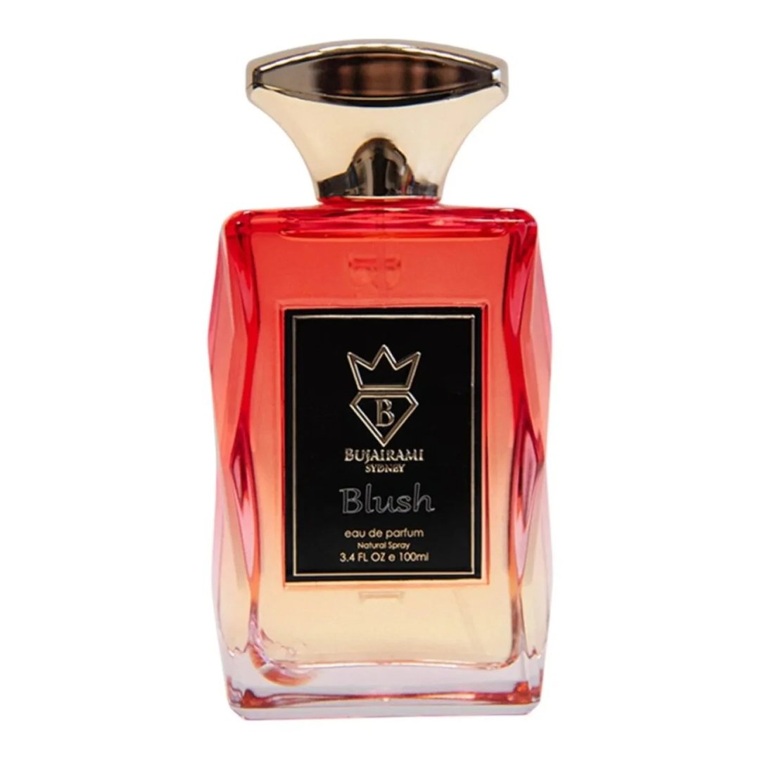 Bujairami Blush by Bujairami Eau de Parfum 100ml — A faceted glass perfume bottle with a gradient of red to clear liquid, topped with a gold cap. The label is black with gold text and a crown logo.