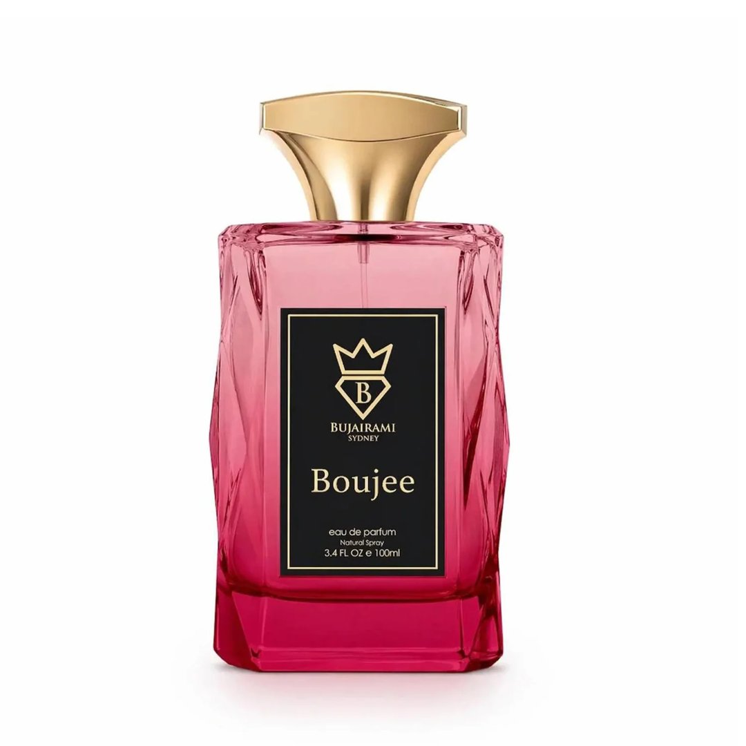 Bujairami Boujee by Bujairami 100ml EDP — Pink faceted glass perfume bottle with a gold cap and a black label featuring a crown and the name 'Boujee'.