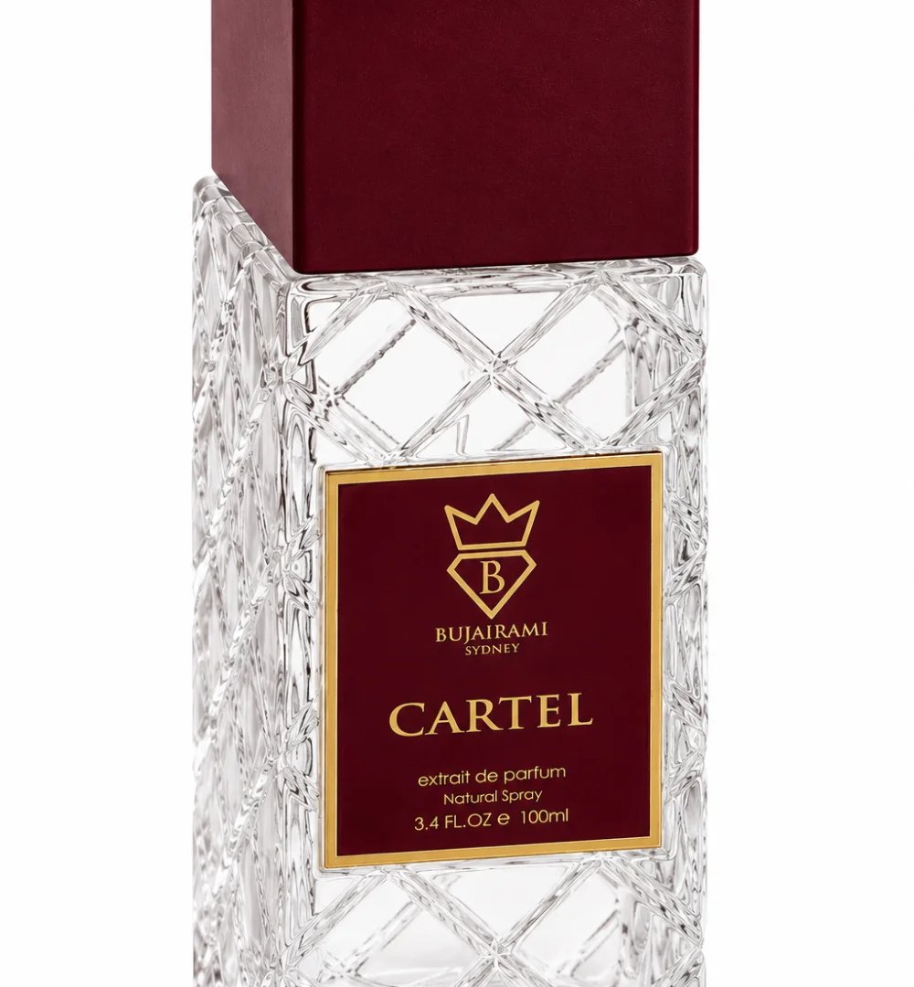 Bujairami Cartel by Bujairami 100ml Extrait — Clear faceted glass bottle with a deep red cap and a maroon label featuring a gold crown logo and text.