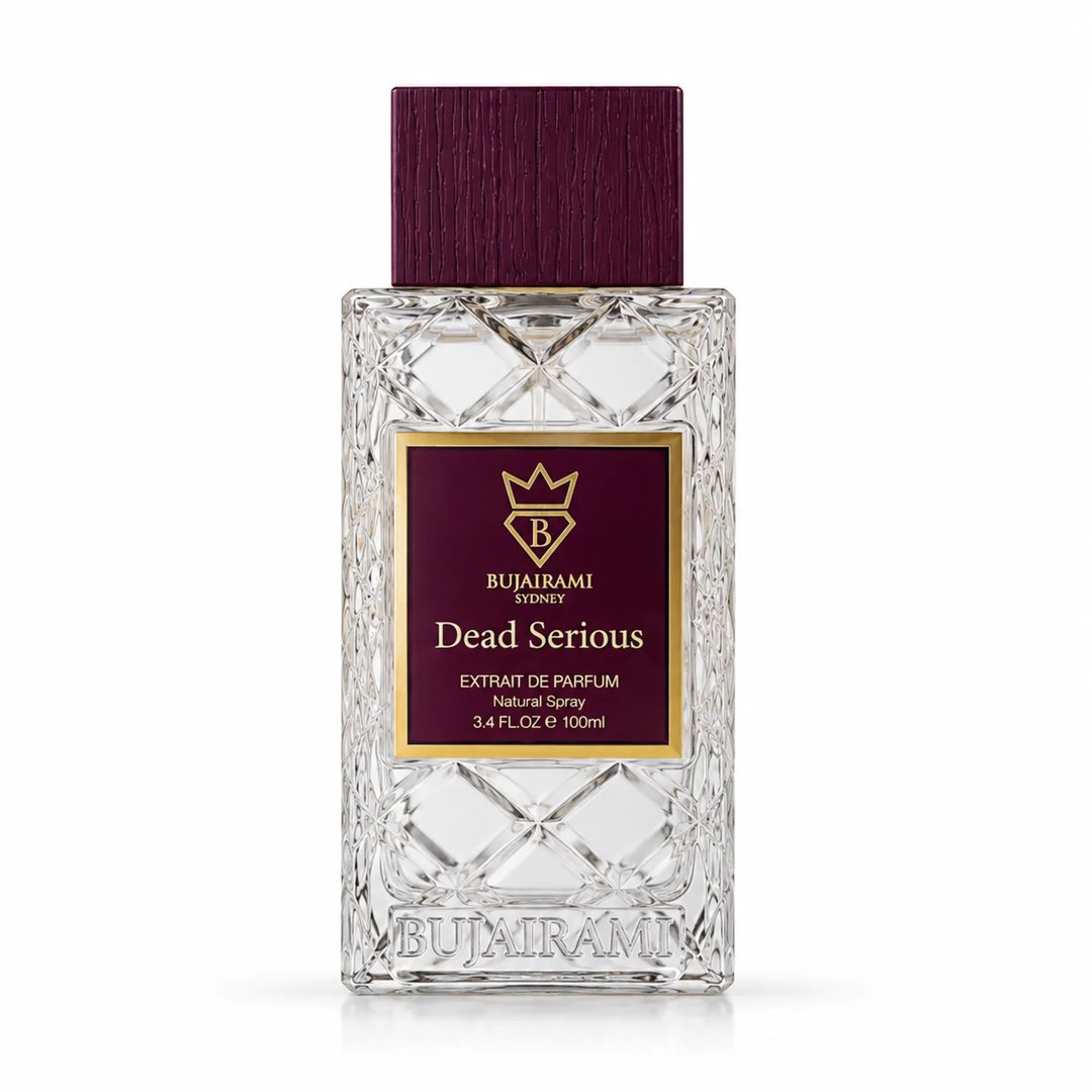 Bujairami Dead Serious by Bujairami 100ml Extrait Unisex — Clear faceted glass perfume bottle with a deep red textured cap and a rectangular label featuring a gold crown logo and "Dead Serious" text.