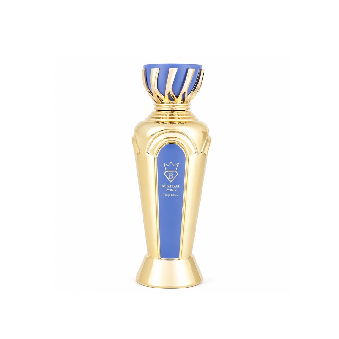 Bujairami Drip No. 7 Bujairami 100ml EDP — A tall, ornate gold perfume bottle with a blue accent panel and a crown-like gold and blue cap, set against a white background.