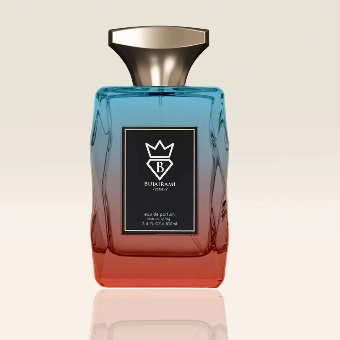 Bujairami Ghost by Bujairami 100ml EDP — A gradient glass perfume bottle with blue fading to orange, featuring a black label with a crown and 'B' logo, and gold cap.