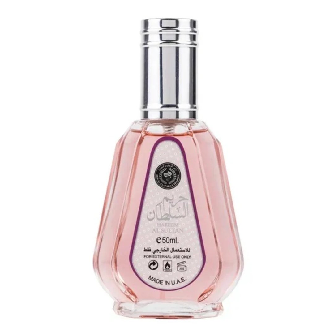 Ard Al Zaafaran Hareem Al Sultan EDP 50ml — Pink glass perfume bottle with a silver cap and a decorative label featuring Arabic script and "Hareem Al Sultan" text. | Ard Al Zaafaran Hareem Al Sultan EDP 50ml — Botol minyak wangi kaca merah jambu dengan penutup perak dan label hiasan yang menampilkan tulisan Arab dan