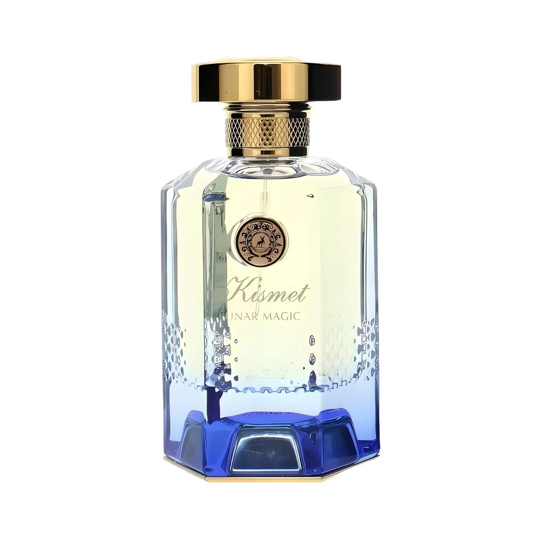 Maison Alhambra Kismet Lunar Magic 100ml — Clear glass perfume bottle with a gold cap and a blue faceted base, featuring a circular emblem and "Kismet Lunar Magic" text. | Botol minyak wangi kaca jernih dengan penutup emas dan tapak biru berfaset, menampilkan lambang bulat dan teks "Kismet Lunar Magic".
