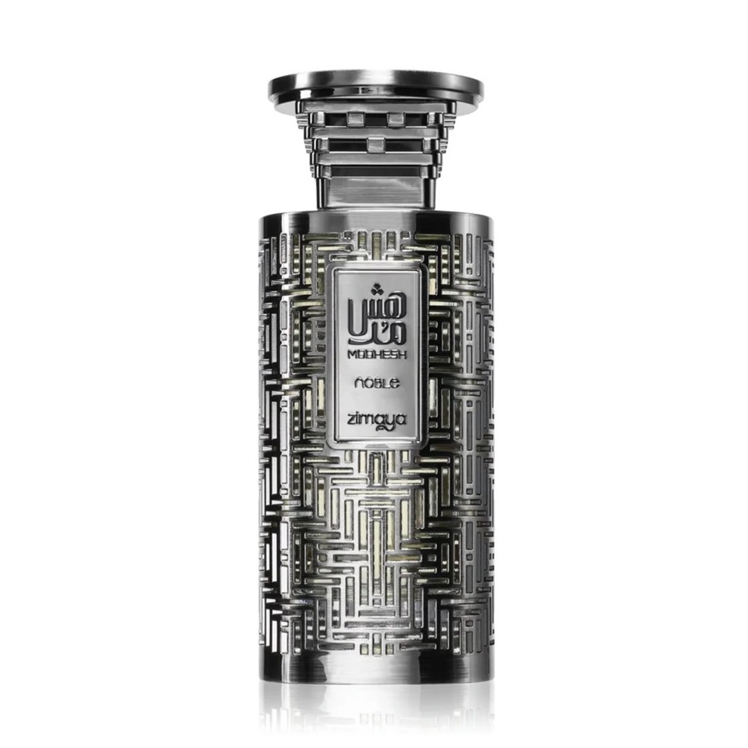 Zimaya Modhesh Noble 100ml by Zimaya — A metallic silver perfume bottle with an intricate geometric pattern and Arabic calligraphy on the label, set against a white background. | Zimaya Modhesh Noble 100ml by Zimaya — Botol minyak wangi perak metalik dengan corak geometri yang rumit dan kaligrafi Arab pada label