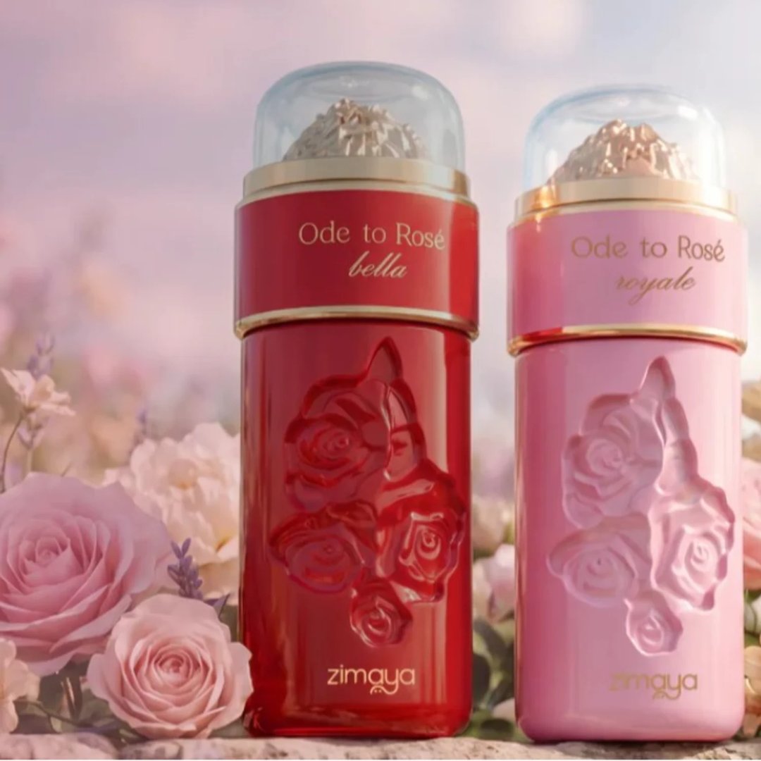 Zimaya Ode to Rose Royale Eau De Parfum 100ml by Zimaya — Two perfume bottles, one red and one pink, with rose embossed designs and clear caps containing gold-colored material, set against a soft focus background of pink and white roses. | Zimaya Ode to Rose Royale Eau De Parfum 100ml by Zimaya — Dua botol minyak