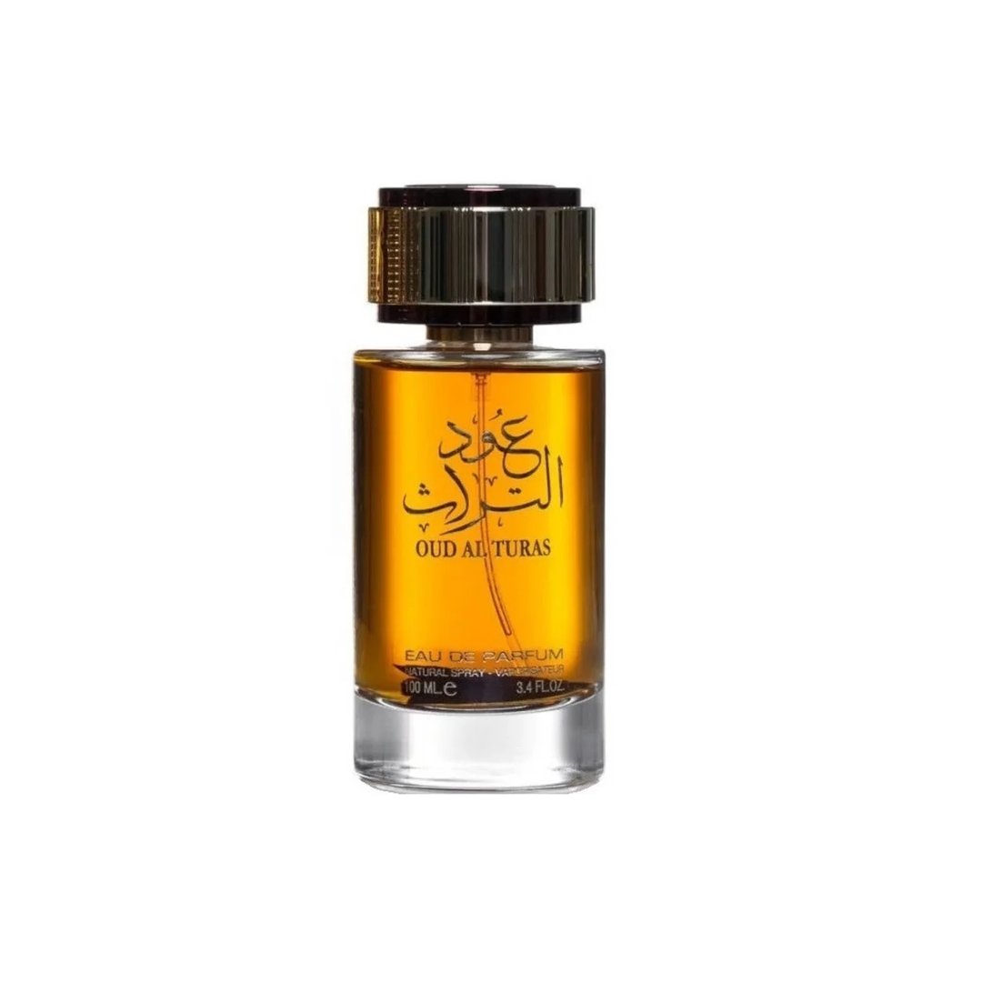 Ard Al Zaafaran Oud Al Turas 100ml by Ard Al Zaafaran — A clear glass perfume bottle with golden liquid and Arabic calligraphy on the label, topped with a textured gold cap. | Ard Al Zaafaran Oud Al Turas 100ml by Ard Al Zaafaran — Botol minyak wangi kaca jernih dengan cecair keemasan dan kaligrafi Arab pada label, di