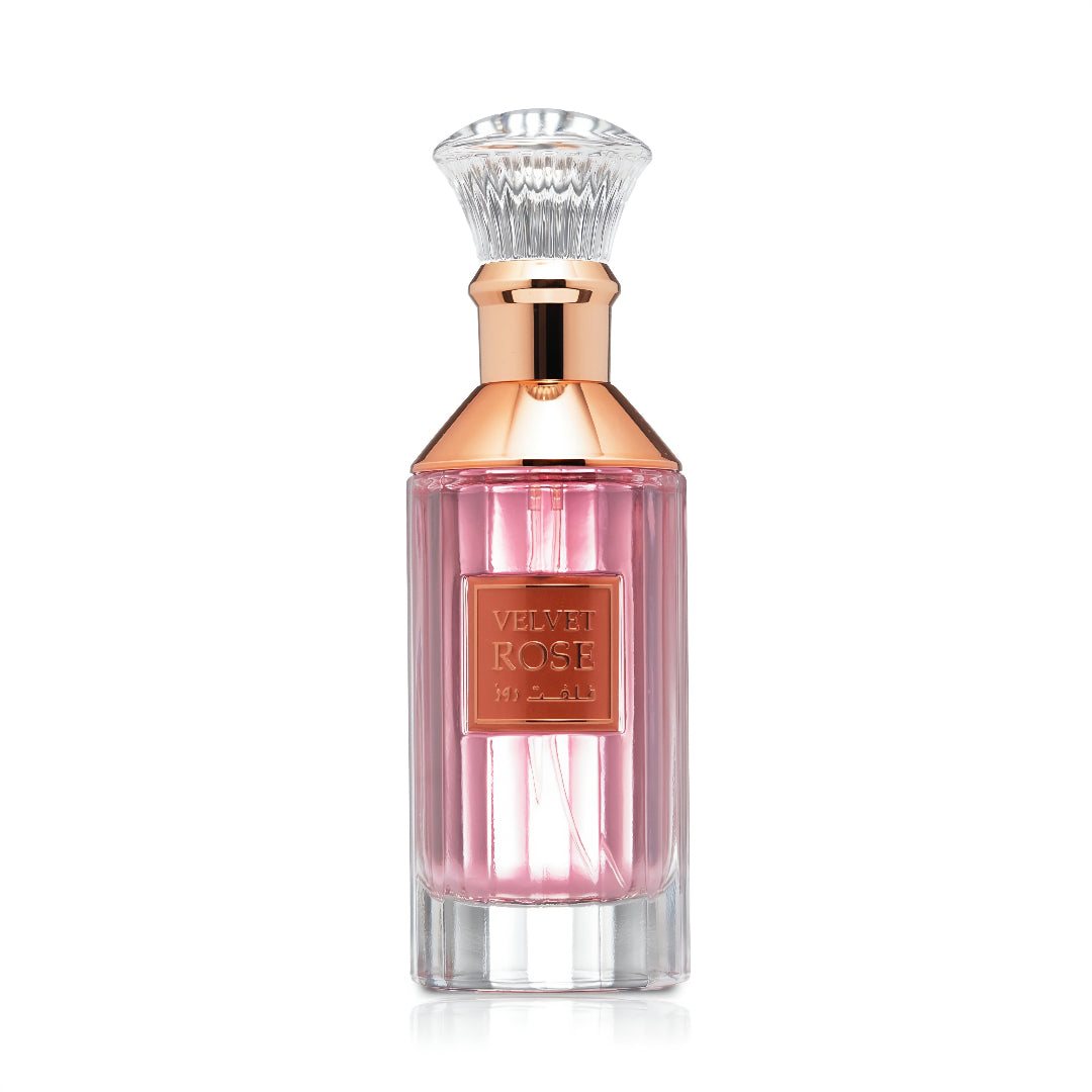Lattafa Velvet Rose by Lattafa 100ml Unisex — Pink perfume in a fluted glass bottle with a rose gold collar and a clear faceted cap, against a white background.