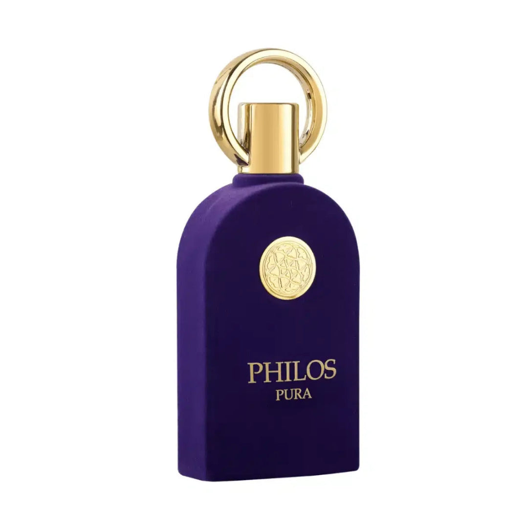Maison Alhambra Philos Pura by Maison Alhambra 100ml EDP Man — A deep purple velvet-textured perfume bottle with a gold circular emblem and a gold ring cap, set against a white background.