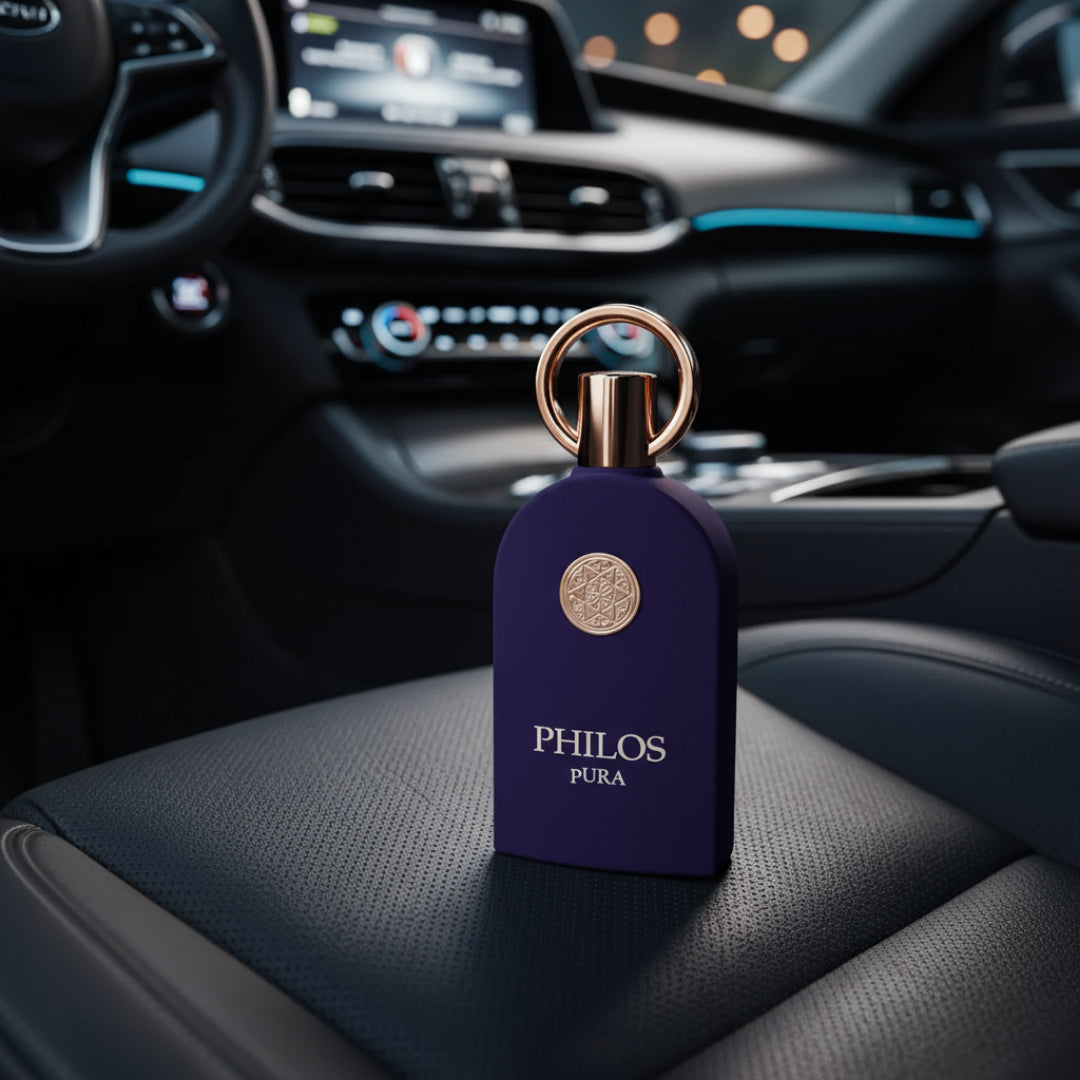 Maison Alhambra Philos Pura by Maison Alhambra 100ml EDP Man — A dark purple perfume bottle with a gold ring and emblem sits on a black leather car seat, with the car's dashboard blurred in the background.