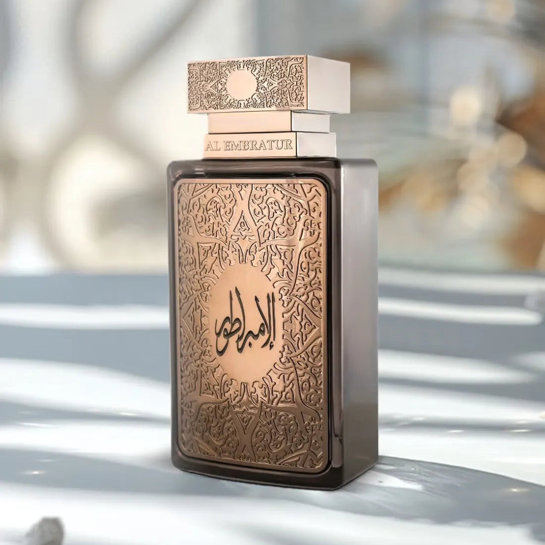 Zimaya Al Embratur Elixir by Zimaya 100ml EDP — Close-up of a dark grey perfume bottle with ornate gold Arabic calligraphy on the front panel and a stacked gold cap.