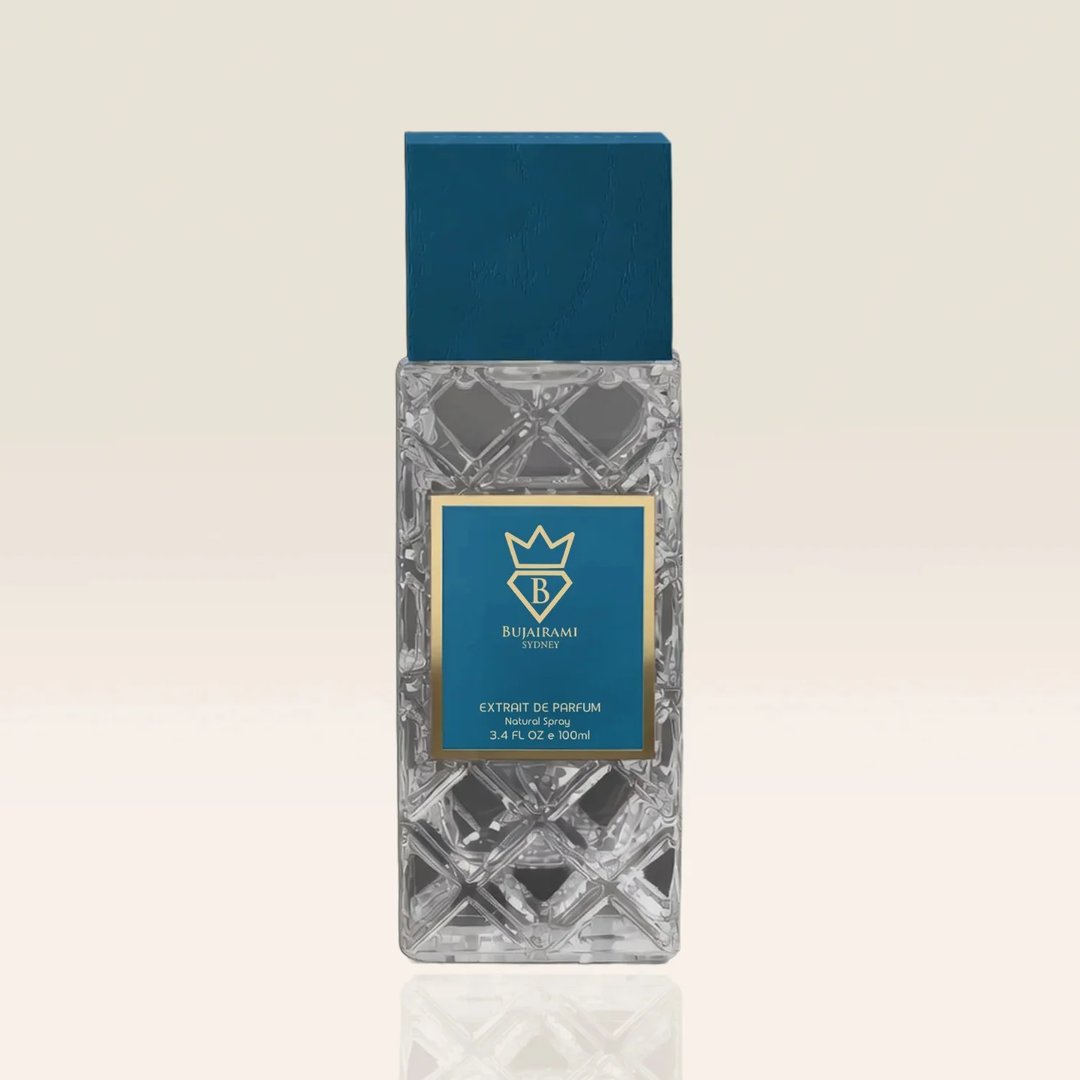 Bujairami Real Deal Fresh Citrus Musk 100ml Extrait — Clear faceted glass bottle with a textured teal cap and a blue label featuring a gold crown logo and text.