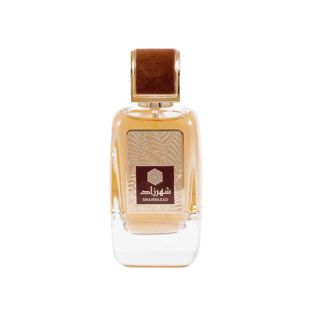 Ard Al Zaafaran Shahrazad Eau De Parfum — Botol kaca jernih berisi cecair keemasan, dengan penutup coklat baldu dan perincian emas pada label.