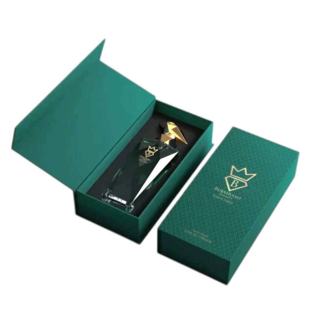 Bujairami Silent Halo by Bujairami 100ml Extrait — Green gift box open to reveal a clear glass perfume bottle with a gold cap, set against a white background.