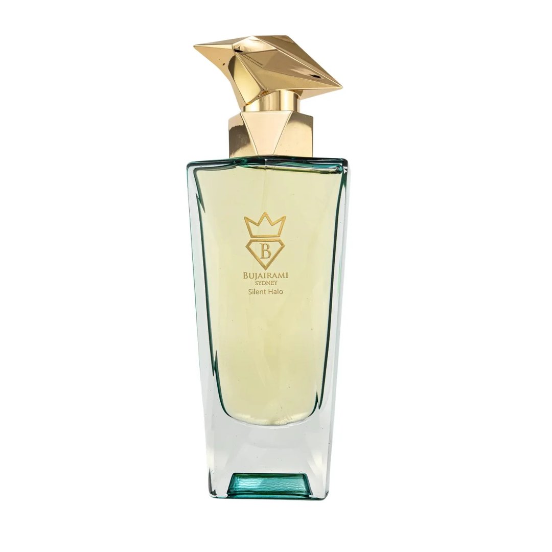 Bujairami Silent Halo by Bujairami 100ml Extrait — A clear glass perfume bottle with a geometric gold cap, filled with pale yellow liquid, featuring the Bujairami logo and product name.