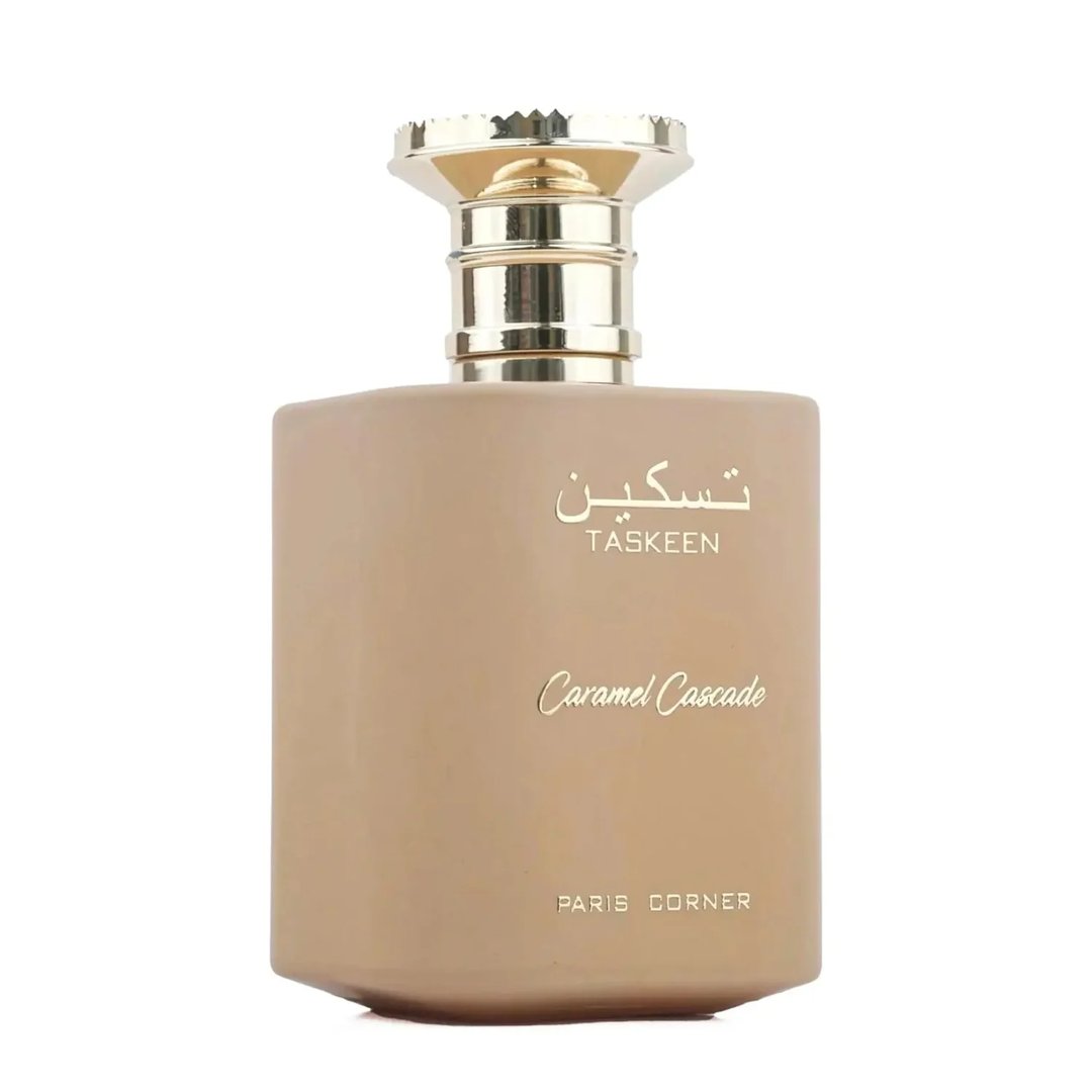 Paris Corner Taskeen Caramel Cascade 100ml — A light brown square perfume bottle with a gold cap, featuring gold Arabic script and text "TASKEEN", "Caramel Cascade", and "PARIS CORNER" | Paris Corner Taskeen Caramel Cascade 100ml — Botol minyak wangi segi empat berwarna coklat muda dengan penutup emas, menampilkan