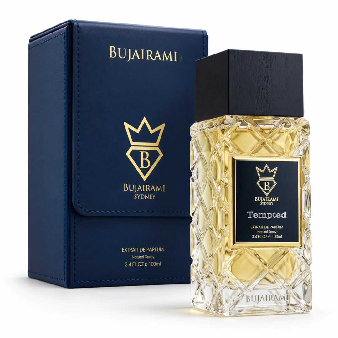 Bujairami Tempted 100ml Extrait Perfume Unisex — Clear faceted glass bottle with gold accents and black cap, next to a navy blue presentation box with gold logo.