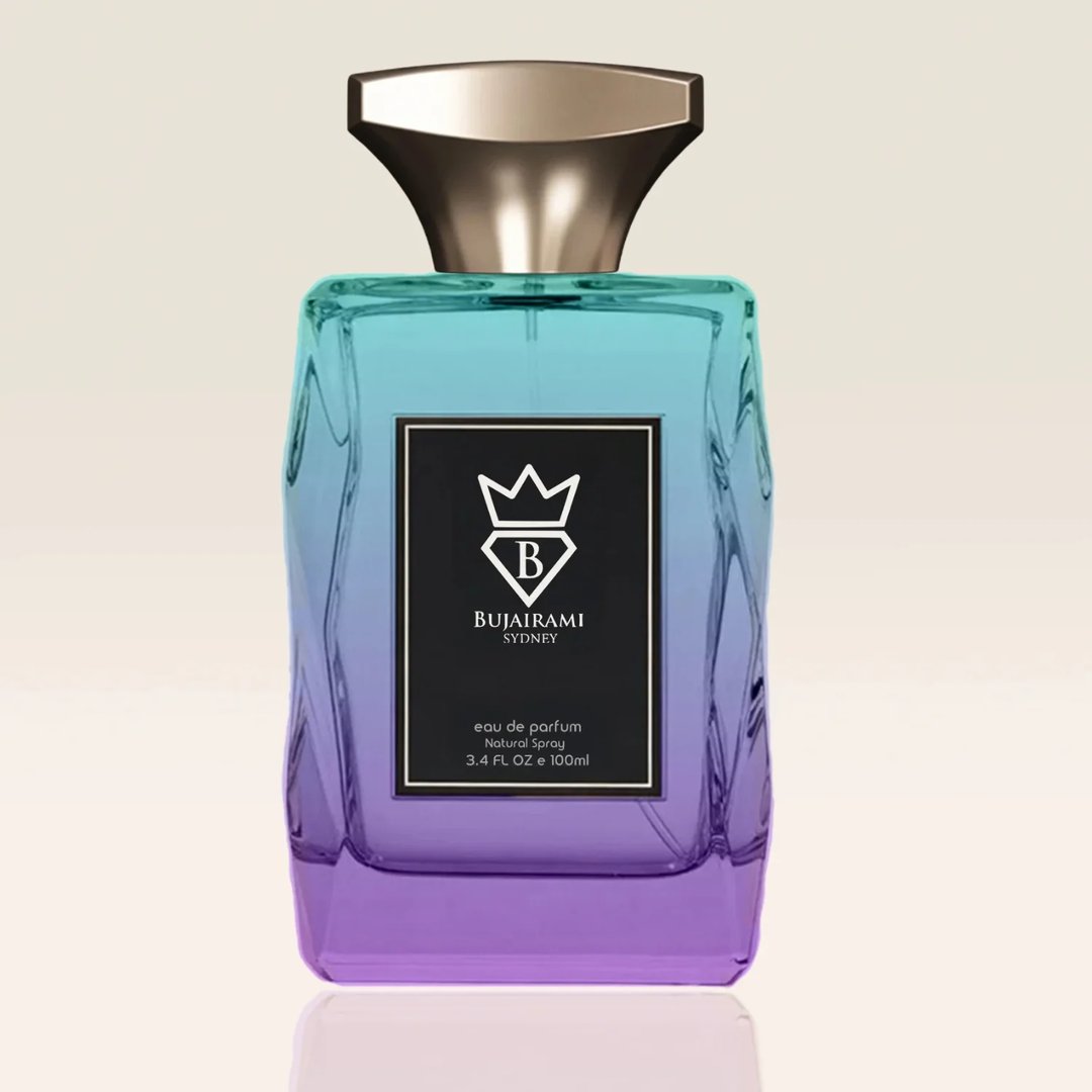 Bujairami Unforgettable by Bujairami Eau de Parfum 100ml — Gradient blue-to-purple glass bottle with a gold cap and a black label featuring a crown and the brand name