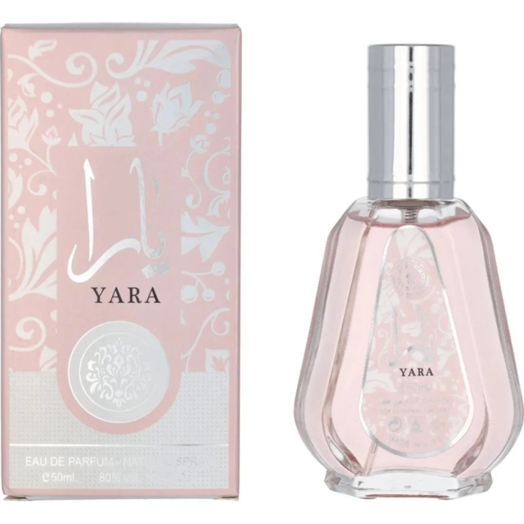 Ard Al Zaafaran Yara Eau De Parfum 50ml — A pink perfume bottle with a silver cap and a pink box with floral patterns, both featuring the Yara logo. | Ard Al Zaafaran Yara Eau De Parfum 50ml — Botol minyak wangi merah jambu dengan penutup perak dan kotak merah jambu dengan corak bunga, kedua-duanya menampilkan logo