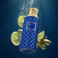 Legacy by Maison Asrar 100ml EDP Unisex — Botol biru corak emas tenggelam dalam air bersama hirisan lemon dan halia