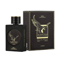 Lattafa Malik Al Tayoor Concentrated 100ml — Black perfume bottle and its black textured box with a golden eagle emblem, set against a white background. | Botol minyak wangi hitam dan kotaknya yang bertekstur hitam dengan lambang helang emas, berlatar belakang putih.