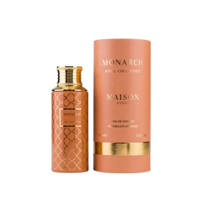 Maison Asrar Monarch Royal Collection — Orange bottle with gold geometric pattern and gold cap, next to a matching orange cylindrical box with gold accents.