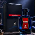 Maison Alhambra Moondrift Blue Intense 100ml — A blue glass perfume bottle with a red label and gold deer logo, next to its matching blue box with a red label. | Maison Alhambra Moondrift Blue Intense 100ml — Botol kaca biru dengan label merah dan logo rusa emas, bersebelahan dengan kotak birunya yang sepadan dengan