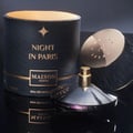 Maison Asrar Night In Paris EDP — Kotak hitam bertekstur dengan aksen emas, botol minyak wangi bertutup emas, dan penutup di atas permukaan hitam reflektif.