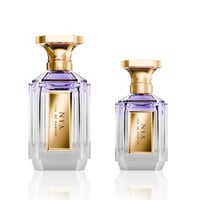 Velixir Nyx Velixir Parfums 100ml for Unisex — Two clear glass perfume bottles with gold caps and purple liquid, one larger than the other, displayed side-by-side on a white reflective surface. | Velixir Nyx Velixir Parfums 100ml for Unisex — Dua botol minyak wangi kaca jernih dengan penutup emas dan cecair ungu, satu