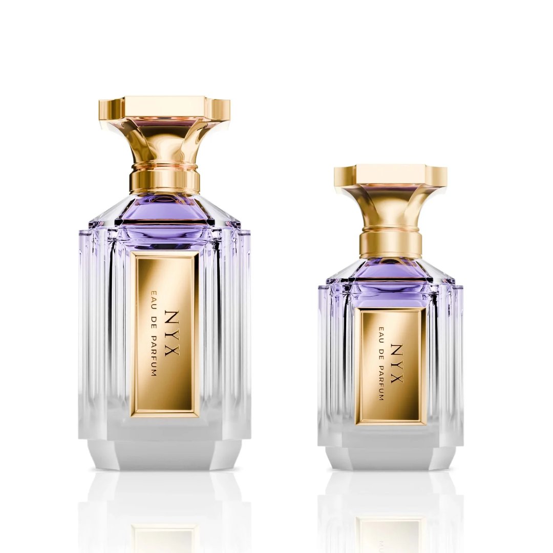 Velixir Nyx Velixir Parfums 100ml for Unisex — Two clear glass perfume bottles with gold caps and purple liquid, one larger than the other, displayed side-by-side on a white reflective surface. | Velixir Nyx Velixir Parfums 100ml for Unisex — Dua botol minyak wangi kaca jernih dengan penutup emas dan cecair ungu, satu