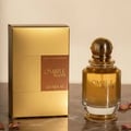 Khadlaj Ombre Notes by Khadlaj 100ml EDP Unisex — Gold box and glass perfume bottle with gold cap, presented on a marble surface with dried rose petals.
