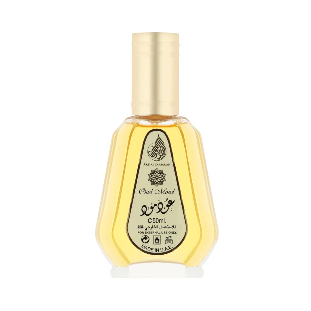 Ard Al Zaafaran Oud Mood by Ard Al Zaafaran 50ml EDP Unisex — A clear glass perfume bottle with a gold cap, filled with yellow liquid. The label features Arabic script and "Oud Mood" in English.