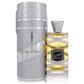 Lattafa Oud Mood Reminiscence — A silver cylindrical box stands next to a clear glass perfume bottle with yellow liquid and a silver cap, both featuring ornate silver detailing and the text 'Oud Mood Reminiscence'. | Lattafa Oud Mood Reminiscence — Kotak silinder perak berdiri di sebelah botol minyak wangi kaca jernih