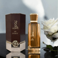 Afnan 9 PM - Pour Femme Afnan Perfumes 100 ml Women — Woman in green hijab holding purple perfume bottle inside a car at