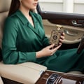 Al Wataniah Ain Emarat — Brown ribbed box with gold eagle emblem next to amber glass perfume bottle with gold accents