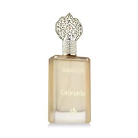 Al Wataniah Granada – Clear glass perfume bottle with ornate gold cap and Arabic text on label.