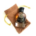 Afnan Supremacy Not Only Intense Extrait 100ml — A metallic gradient perfume bottle with a silver ring cap stands next to