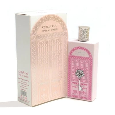 Ard Al Zaafaran Bab Al Wardi — Pink perfume bottle and box with ornate door and key designs, white background