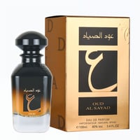 Ard Al Zaafaran Oud Al Sayad — Black and gold bottle with black cap next to a gold box with Arabic script and a large Arabic