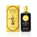 Al Wataniah Sevilla by Al Wataniah 75ml EDP Women — A pink gradient perfume bottle with a decorative gold cap sits next to