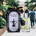 Al Wataniah Selena — Couple holding glowing perfume bottle between them, warm lighting