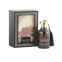 Ard Al Zaafaran Fakhar Al Oud – Black box with gold accents and oud sticks, next to a dark glass bottle with gold cap and