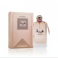 Ard Al Zaafaran Heibah — Pink box and clear glass perfume bottle with pink ribbon and gold cap, set against a white