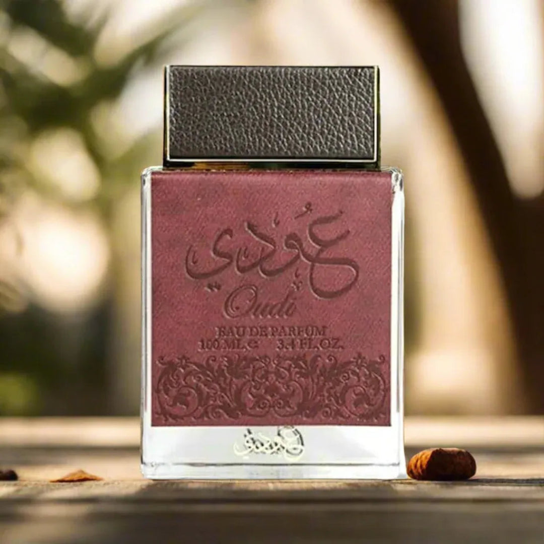 Ard Al Zaafaran Fakhar Al Oud — Amber perfume bottle with gold cap and tassel, emitting fiery smoke and sparks, next to a