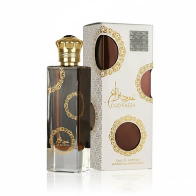 Ard Al Zaafaran Oud Fazza — Clear glass perfume bottle with gold cap and ornate gold circular patterns, next to its white